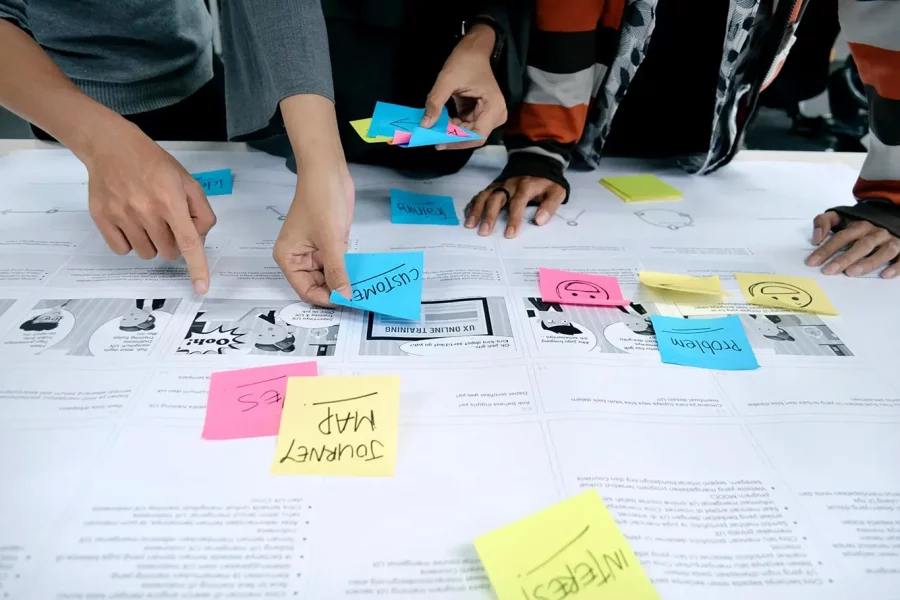Web designers planning the user journey using post-it notes