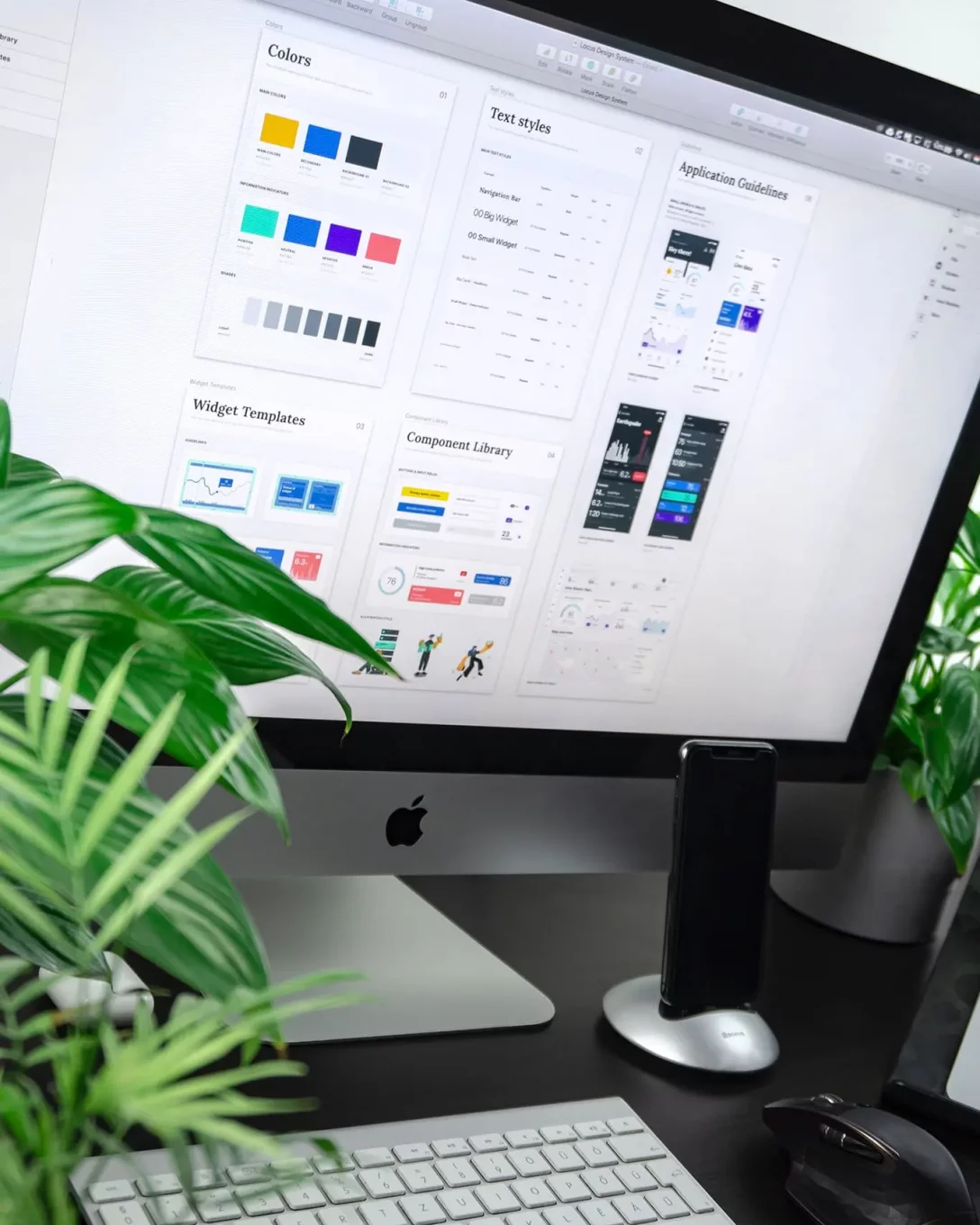 branding ideas displayed on a large iMac with plants on the desk